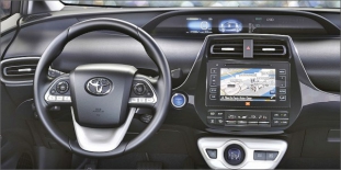 Všechny přístroje a oba displeje má Prius umístěné uprostřed, páčka volby jízdního režimu R-N-D-B se nachází na spodním bílém panelu